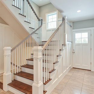 Example of a large transitional wooden u-shaped wood railing staircase design in Other with painted risers