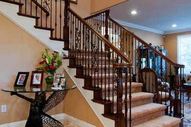 Mid-sized elegant carpeted l-shaped staircase photo in Los Angeles with carpeted risers