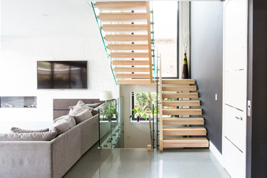 Inspiration for a contemporary staircase in Toronto with feature lighting.