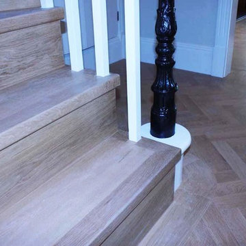 Solid walnut parquet floor in a herringbone pattern with matching staircase