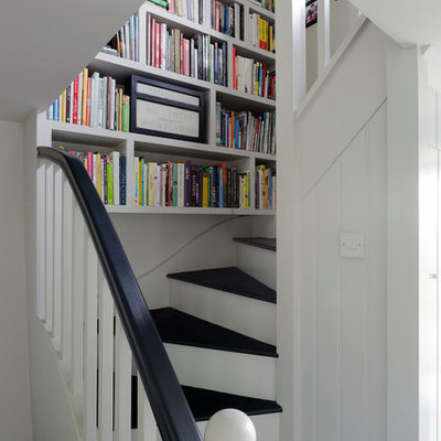 Inspiration for a small farmhouse wooden curved staircase remodel in Cornwall with painted risers