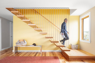 Wood straight staircase in Portland Maine with open risers.