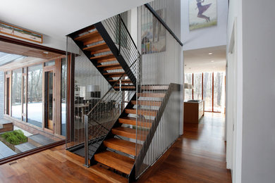 Staircase - mid-sized contemporary wooden u-shaped open and metal railing staircase idea in New York