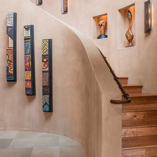 Staircase - mid-sized southwestern wooden curved staircase idea in Phoenix with wooden risers