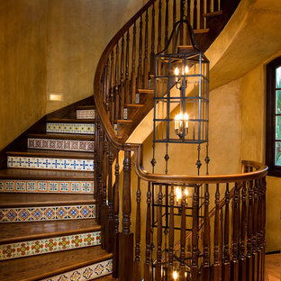 Design ideas for a mediterranean wood staircase in Tampa with tiled risers.