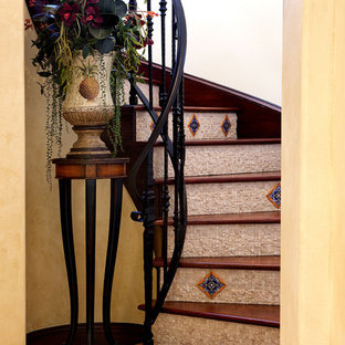 Mediterranean wood curved staircase in Orlando with tiled risers.