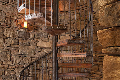 Inspiration for a large rustic wood spiral staircase in Denver with open risers.