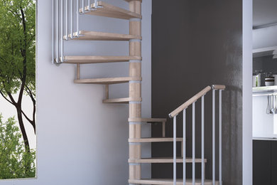 Diseño de escalera de caracol contemporánea de tamaño medio sin contrahuella con escalones de madera y barandilla de varios materiales