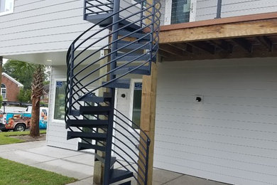 Example of a mid-sized minimalist metal spiral open and metal railing staircase design in Wilmington