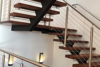 Inspiration for a mid-sized contemporary wooden u-shaped open and metal railing staircase remodel in New York