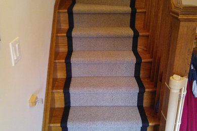 Example of a small classic carpeted curved staircase design in Toronto with carpeted risers