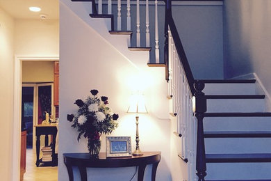 Mid-sized transitional wooden l-shaped wood railing staircase photo in Chicago with painted risers