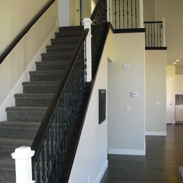 Stair case with black railing and white newel post