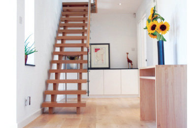 Inspiration for a small modern wood straight staircase in Cambridgeshire with wood risers.