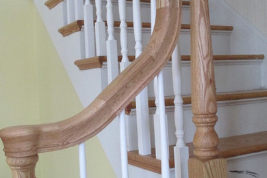 Photo of a medium sized classic wood l-shaped staircase in Other with painted wood risers.