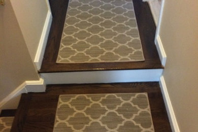 Staircase - small modern carpeted straight staircase idea in New York with carpeted risers