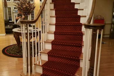 Medium sized wood curved staircase in New York with painted wood risers.