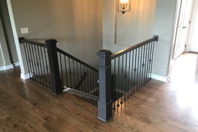Design ideas for a medium sized classic wood u-shaped metal railing staircase in Wichita with painted wood risers.