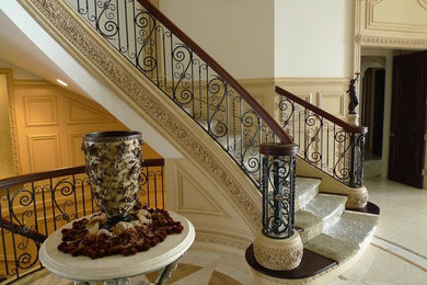 Victorian carpeted curved wood railing staircase in Detroit with carpeted risers.