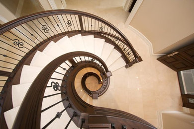 Inspiration for a victorian carpeted spiral wood railing staircase in Detroit with carpeted risers.