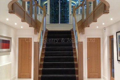 Medium sized contemporary carpeted l-shaped staircase in Other with carpeted risers.