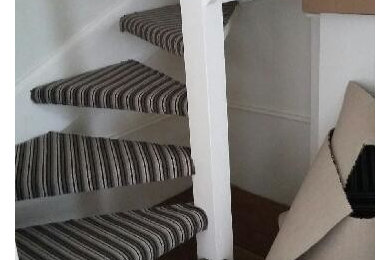This is an example of a medium sized contemporary wood straight staircase in London with open risers.