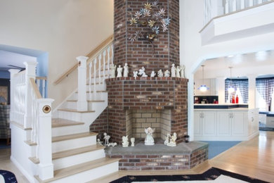 Mid-sized transitional wooden l-shaped wood railing staircase photo in Boston with painted risers