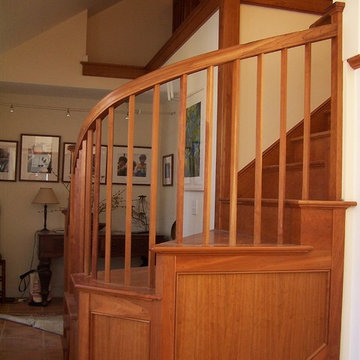 Staircase with curved cherry railing