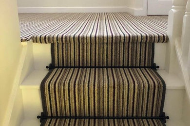 Design ideas for a traditional carpeted straight wood railing staircase in Other with carpeted risers.