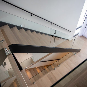 Staircase with metal stringers, glass and spigots/ Escalier avec limons de fer