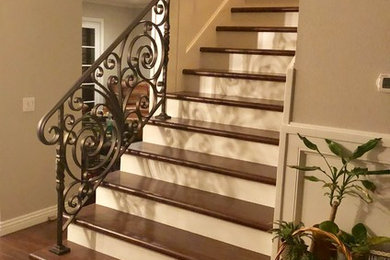 Staircase - mid-sized traditional wooden straight metal railing staircase idea in Los Angeles with wooden risers