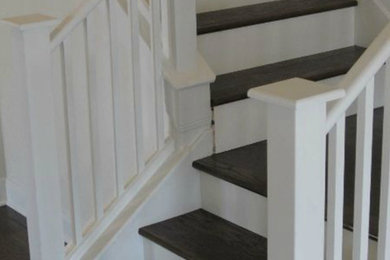 Large wooden l-shaped staircase photo in Austin with wooden risers