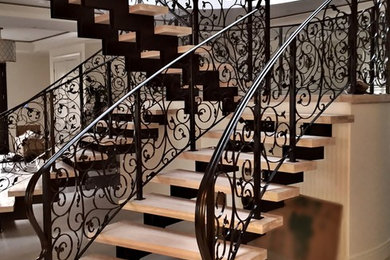 Staircase - large traditional tile u-shaped open and metal railing staircase idea in Vancouver