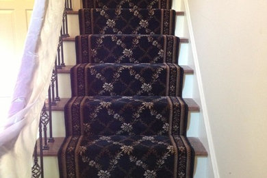 This is an example of a medium sized traditional carpeted straight staircase in St Louis with carpeted risers.