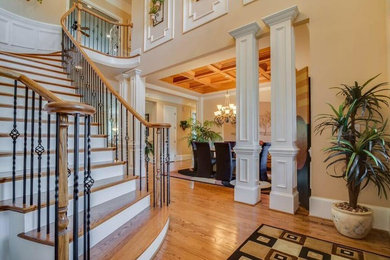 Inspiration for a timeless wooden curved mixed material railing staircase remodel in Orange County with wooden risers