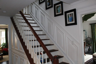Inspiration for a timeless wooden straight staircase remodel in Detroit with painted risers