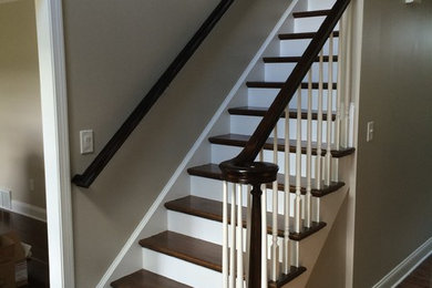 Inspiration for a mid-sized timeless wooden straight staircase remodel in Boston with painted risers