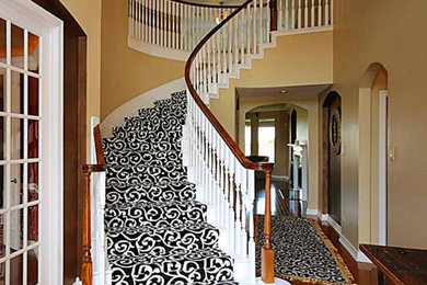 Staircase - carpeted curved staircase idea in Toronto with carpeted risers