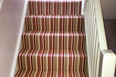 This is an example of an expansive contemporary carpeted straight staircase in London with carpeted risers.