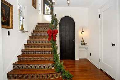 Mid-sized wooden u-shaped staircase photo in San Diego with tile risers