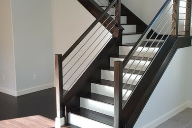 Mid-sized trendy wooden l-shaped cable railing staircase photo in Los Angeles with painted risers