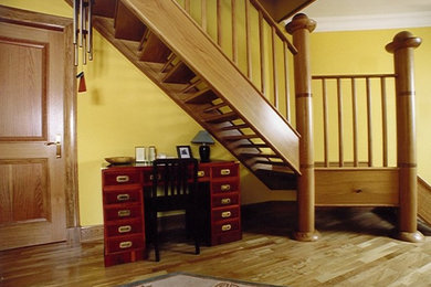 Contemporary wood curved staircase in Edinburgh with open risers.