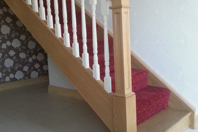 Medium sized traditional carpeted straight staircase in Other with carpeted risers.