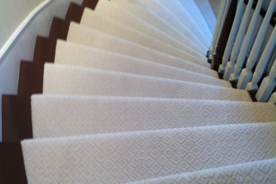 Inspiration for a mid-sized carpeted curved staircase remodel in Los Angeles with painted risers