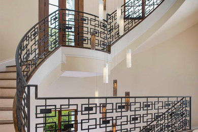 Example of a transitional wooden curved staircase design in Dallas