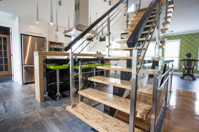Example of a small trendy wooden floating glass railing staircase design in Montreal