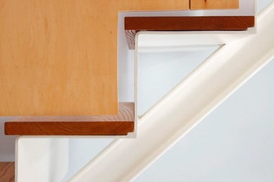 Example of a mid-century modern wooden floating staircase design in San Francisco with metal risers