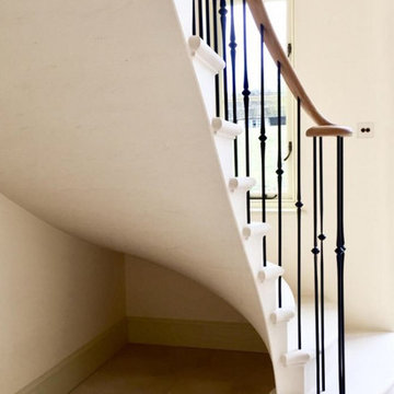 Classic cantilevered Limestone Staircase with simple wrought iron balustrade