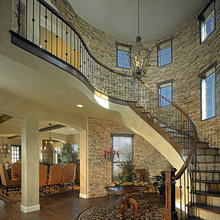 Cool rounded stair case with stone accents on stair risers too