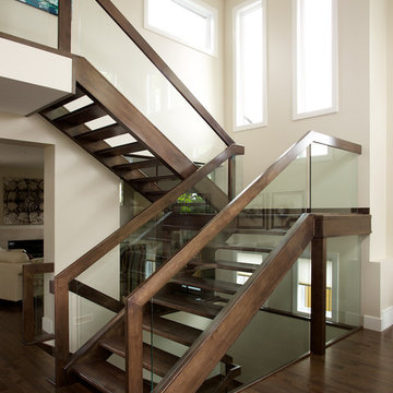 Straight maple stair with glass panel railing